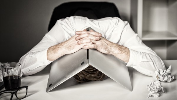 burnout man with laptop on head