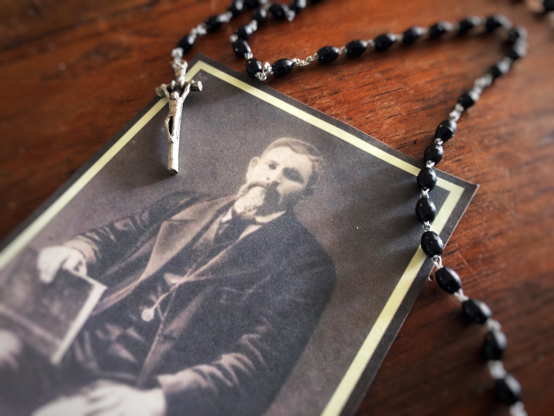 St. Jose Isabel Flores photo on table with rosary