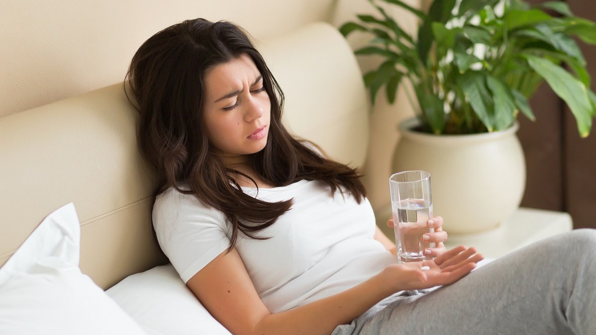 woman debates taking pill