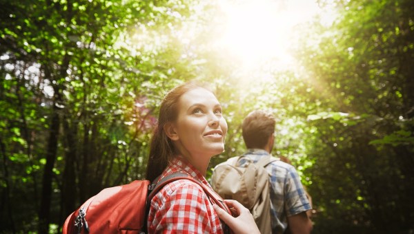 Woman hiking with friends in forest