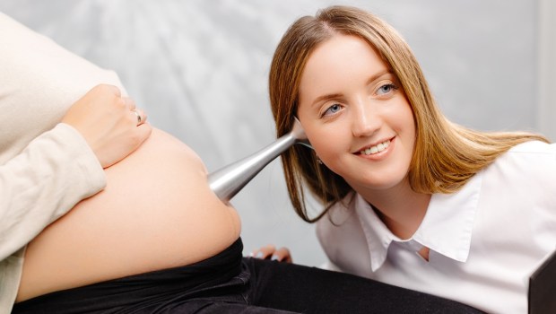 Doctor listening for fetal heartbeat