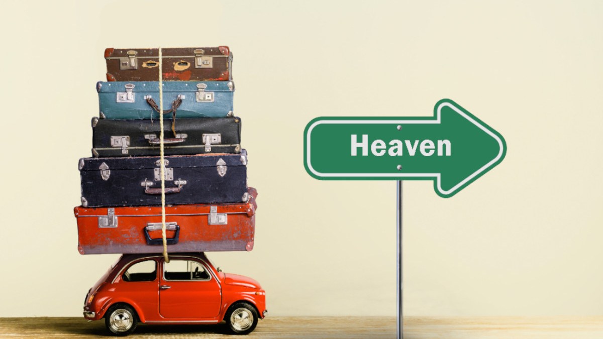 model of family car with luggage and roadsign to heaven