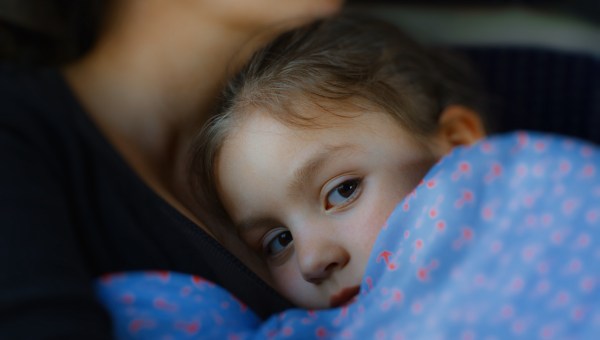 girl cuddle mother neck child blanket