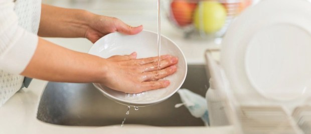 Woman's hands washing dishes
