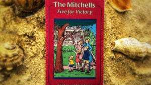 Cover of the book The Mitchells Five for Victory pictured on sand.