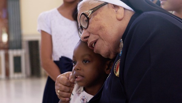 Sr. Maria Rosa Leggo hugging a child