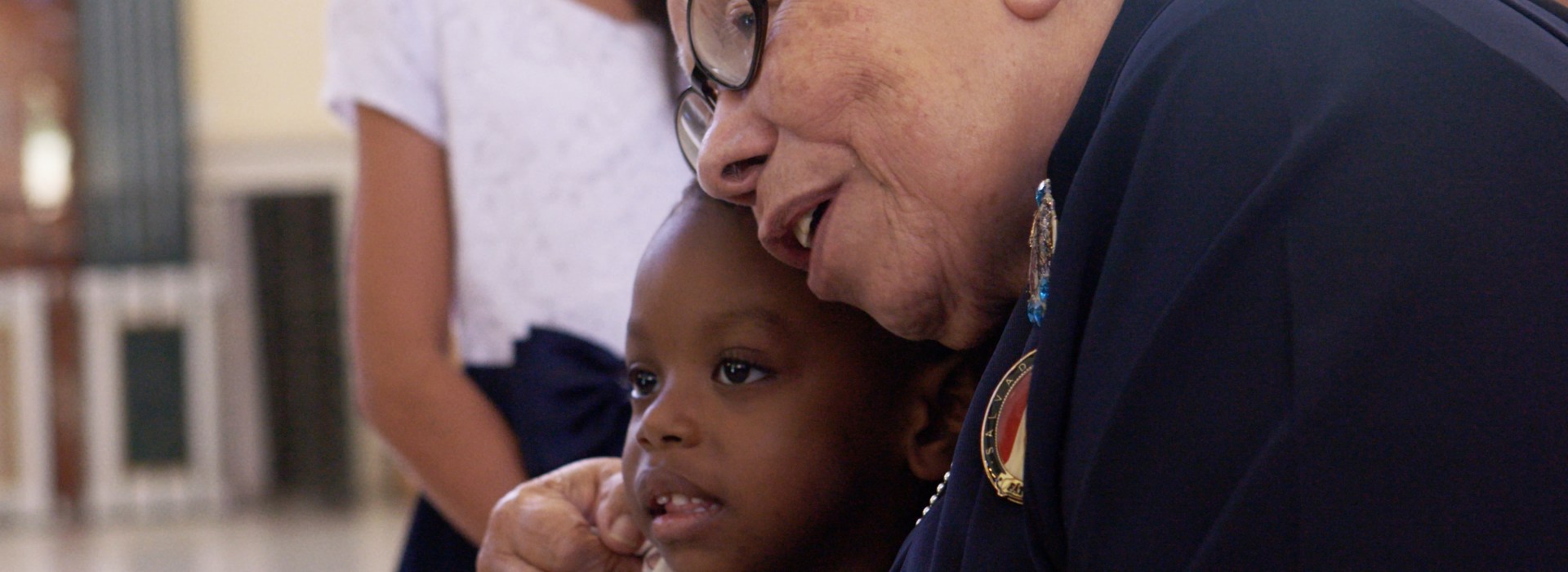 Sr. Maria Rosa Leggo hugging a child