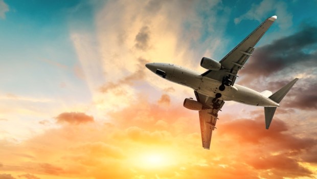 Airliner flying in colorful sky