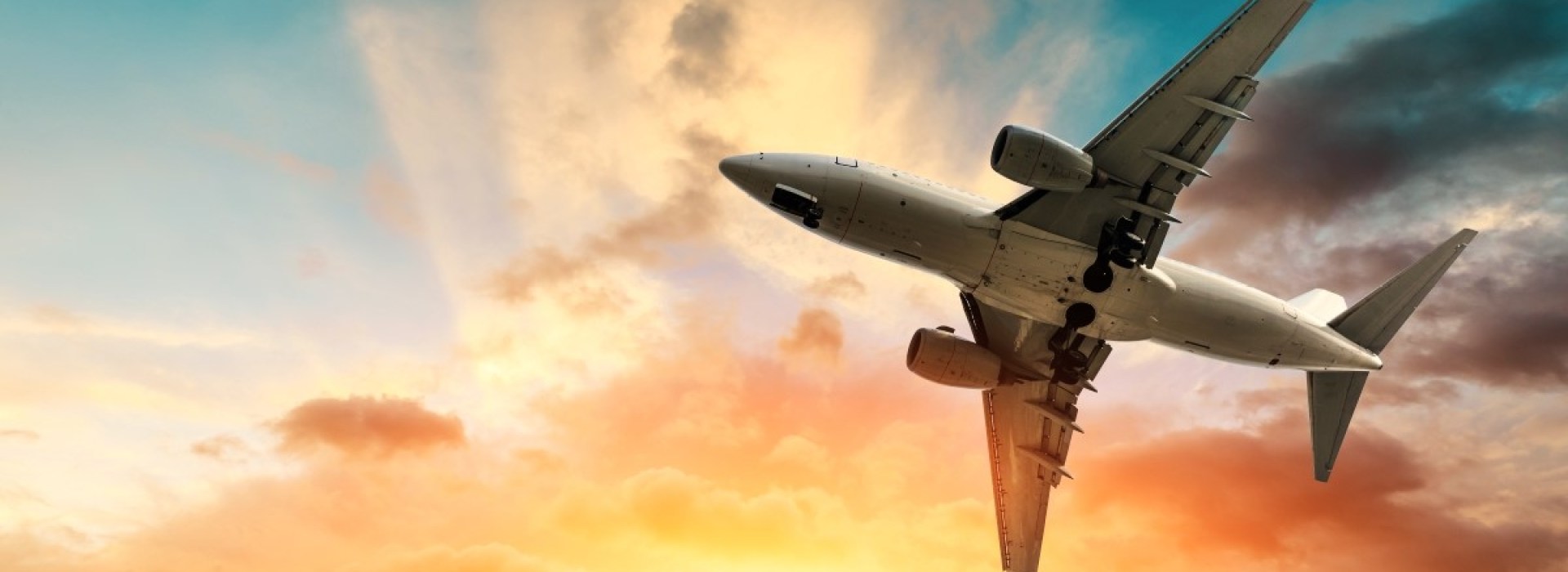 Airliner flying in colorful sky