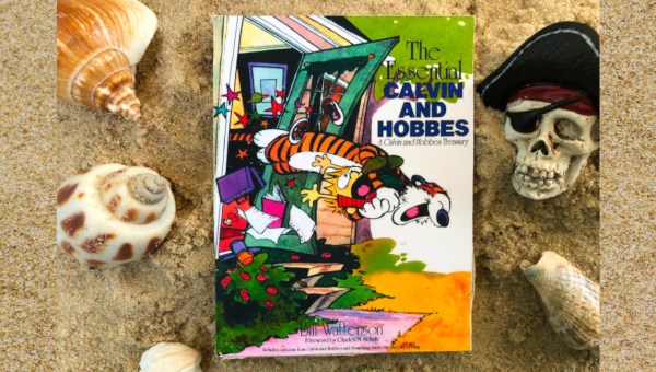 Book "the Essential Calvin and Hobbes" on beach