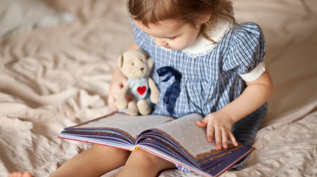 trust child reading teddy bear