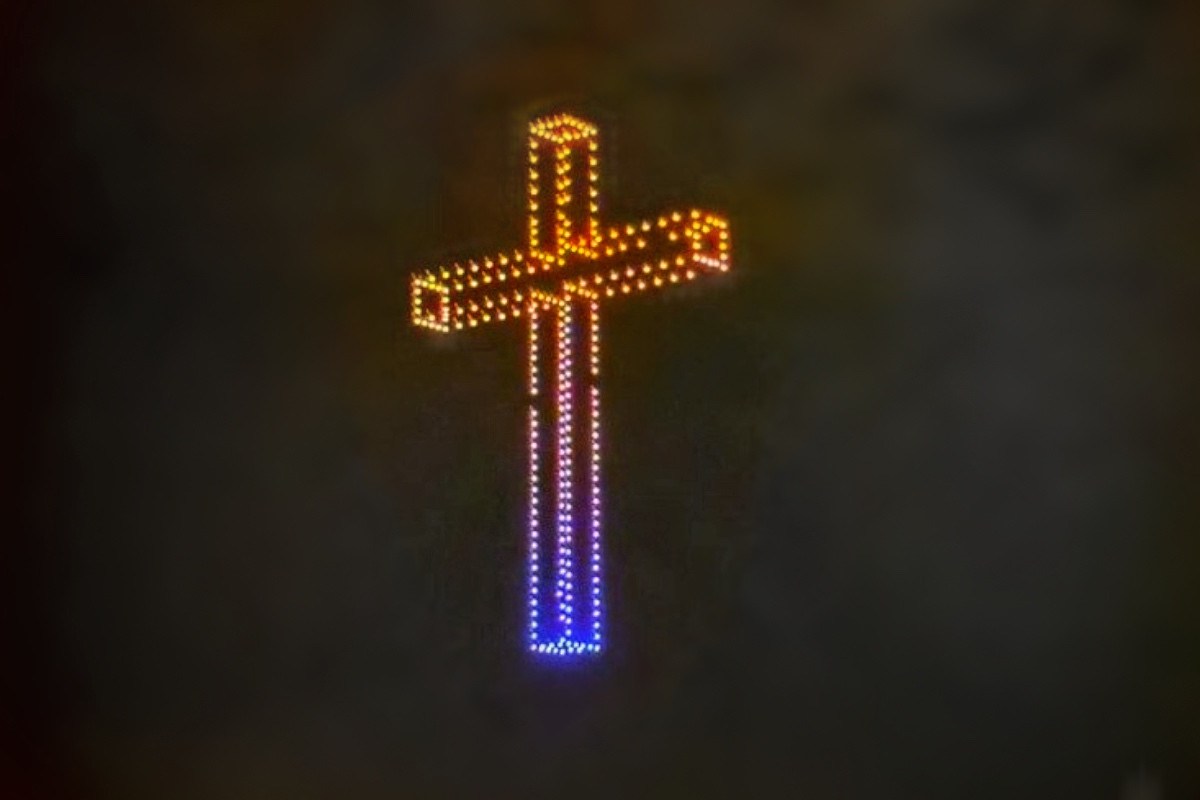 A cross formed by drones with lights in the sky above Budapest