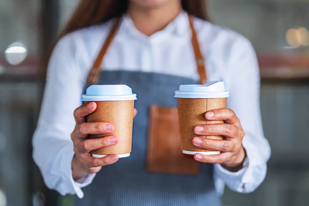 Barrista offering two coffees