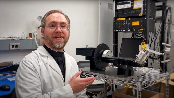 Brother Bob Macke shows off Pycnometer for NASA OSIRIS-REx Mission