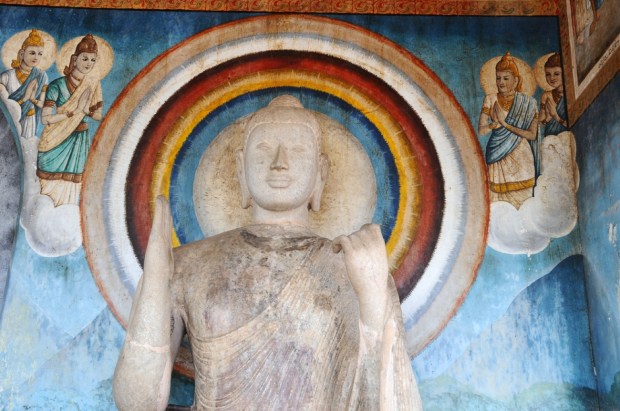 Buddha image statue with beautiful paints on the background on DEC 29, 2013 in Anuradhapura, Sri Lanka