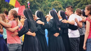 Four nuns singing with young people