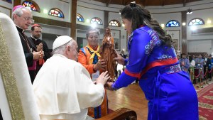Pope Francis blessing a statuette of the Lady Mother of Heaven while presiding over a meeting with bishops, priests, missionaries, consecrates persons and pastoral workers at the Saints Peter and Paul Cathedral in Ulaanbaatar
