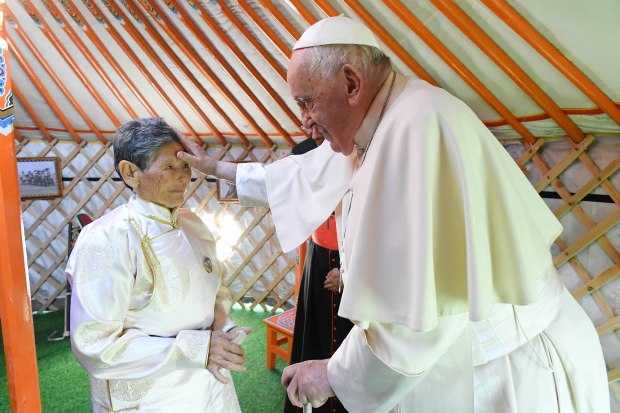 Pope Francis blessing Tsetsege, who some ten years ago had rescued a statuette of the Lady Mother of Heaven from a pile of garbage and later enthroned in the Saints Peter and Paul Cathedral