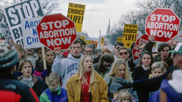 Participants hold placards in the March for Life