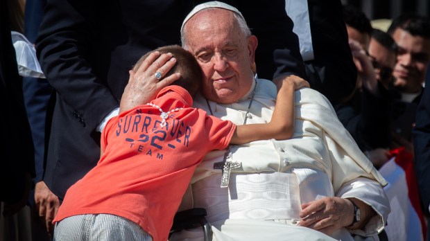 Vatican City, September 06, 2023: Pope Francis hugs a young pilgrim at the end of his weekly general audience in Saint Peter's square