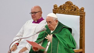 Pope Francis (R) reads the Homily during Holy Mass at the Steppe Arena in Ulaanbaatar