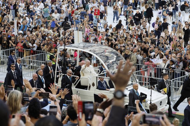Pope Francis waves as he arrives in his popemobile to celebrate mass at the Velodrome stadium