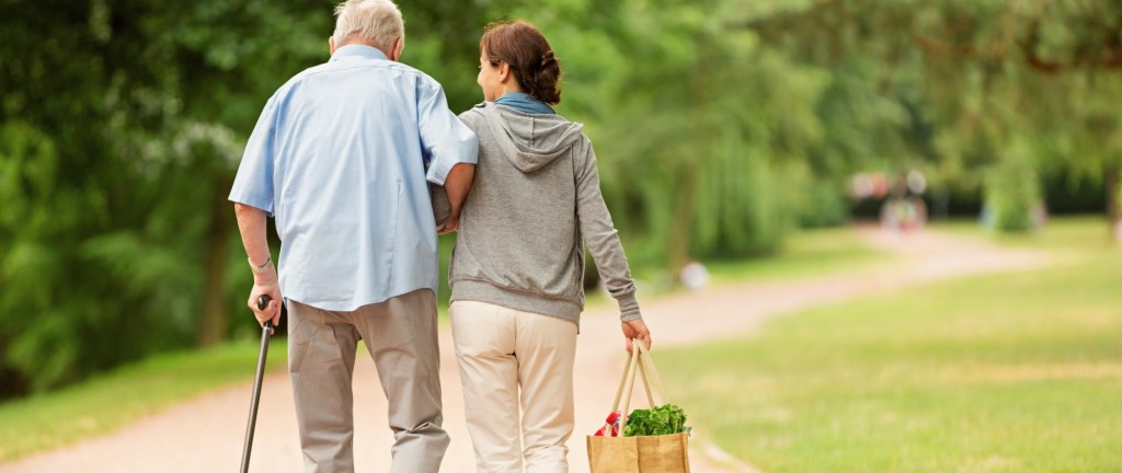 Woman walking with elderly man