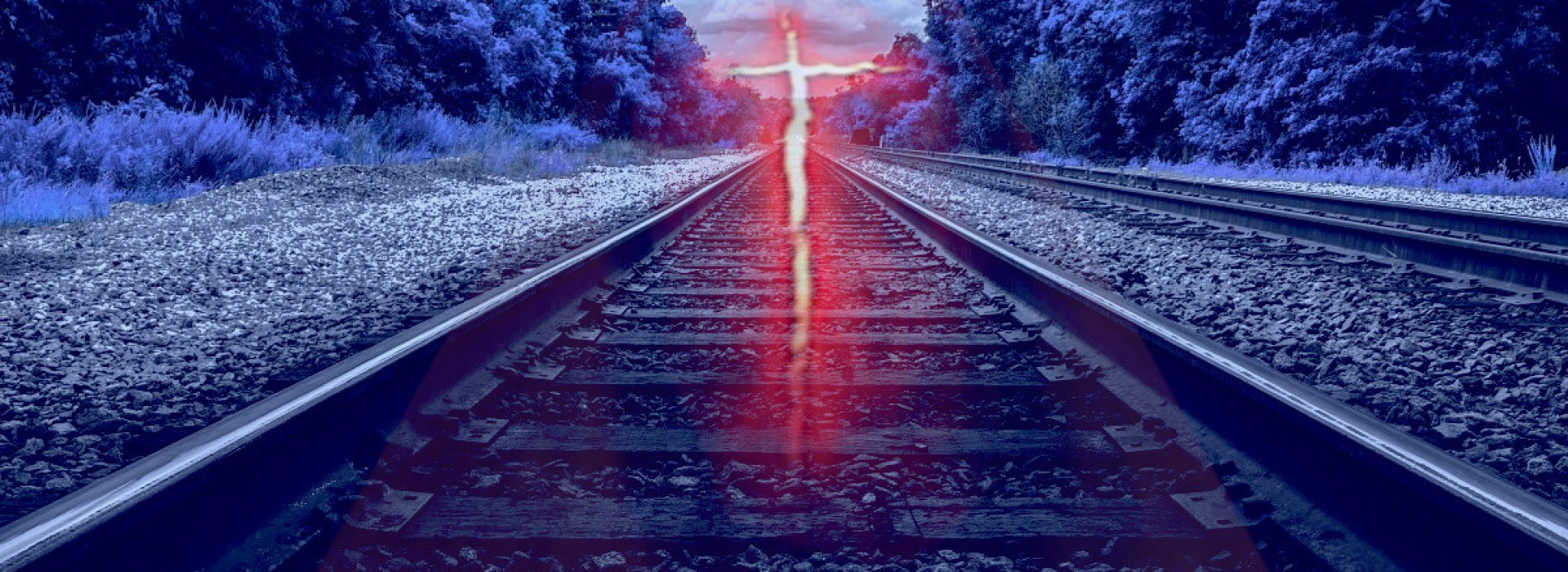 Glowing cross over railroad tracks