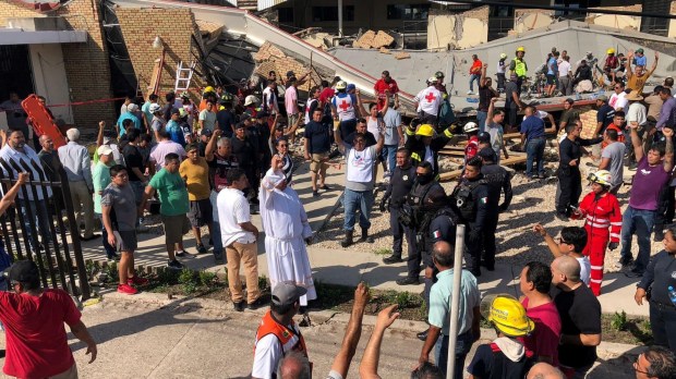 Priest and volunteers help rescue people at Mexico church collapse