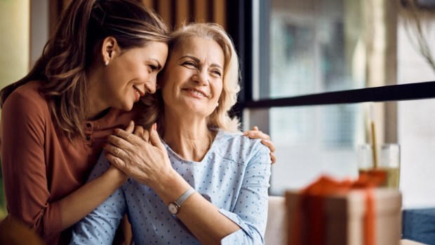 Happy senior woman enjoying in daughter's affection on Mother's day.