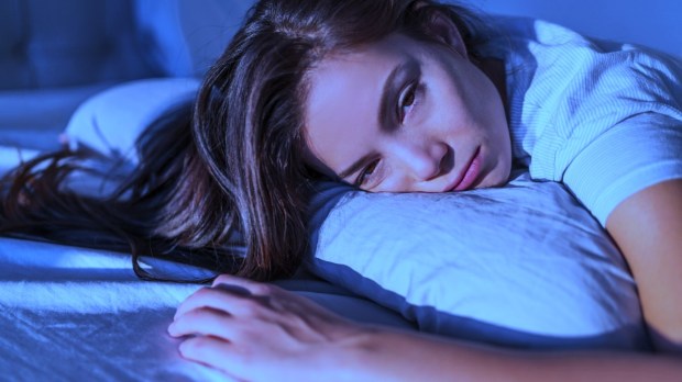 Young woman in bed cannot sleep