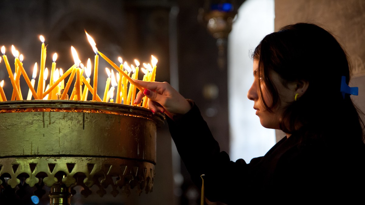 Palestinian youth lights candle in church in 2012