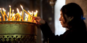 Palestinian youth lights candle in church in 2012