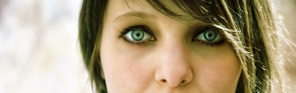 Goth teenage girl looking directly at teh camera with serious look