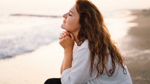 woman-pray-faith-beach