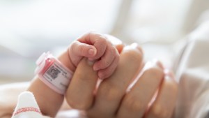 Baby in hospital with mom's hand