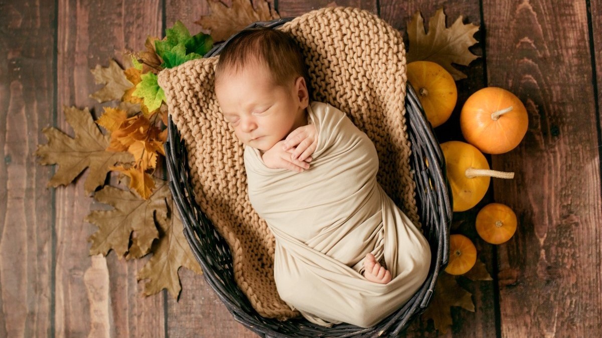 Cute little baby sleeping in a wicker basket