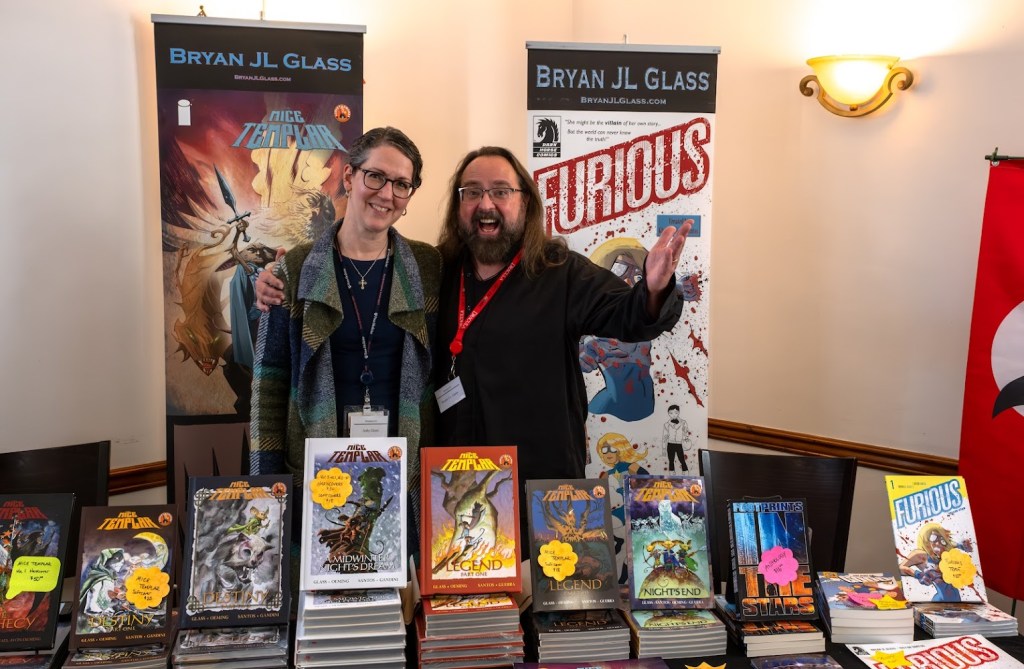 Judy and Bryan J.L. Glass at one of Doxacon's many vendor tables.