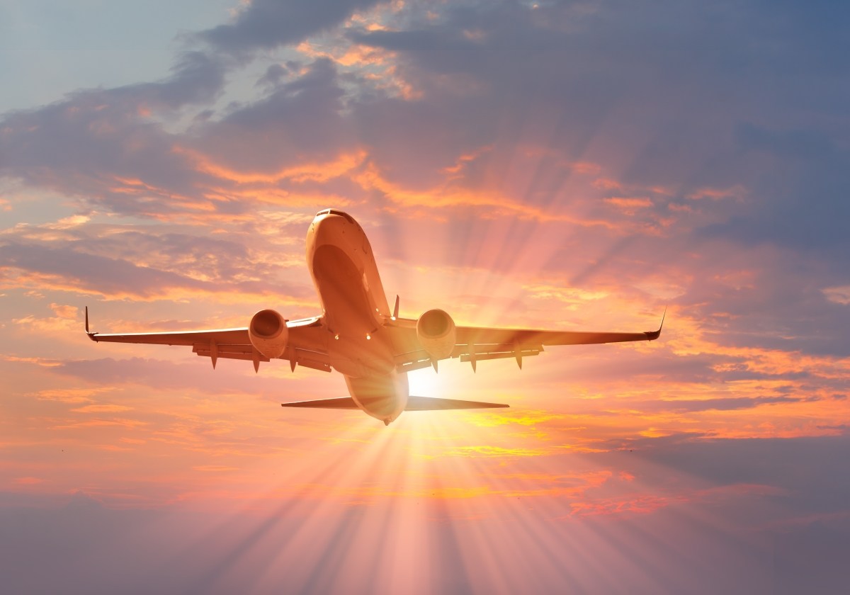 Passenger jet flying at dusk