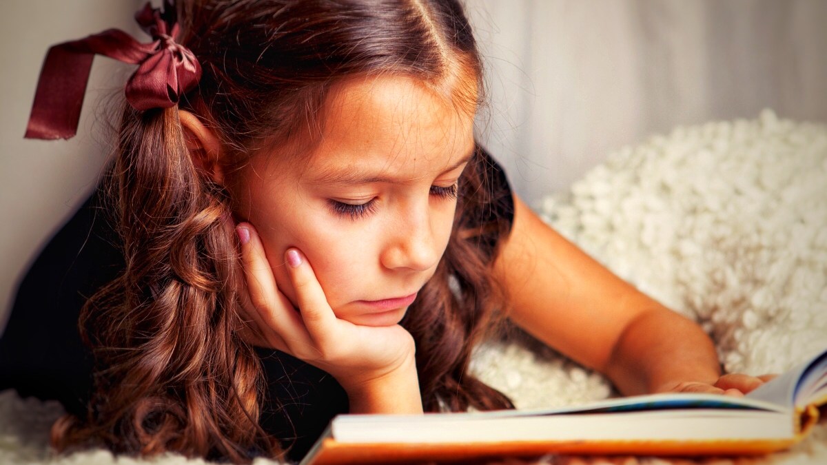 Young girl reading book