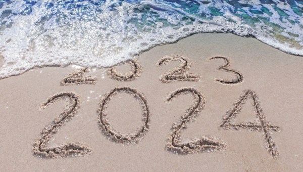 2023 2024 on sand with waves hitting beach