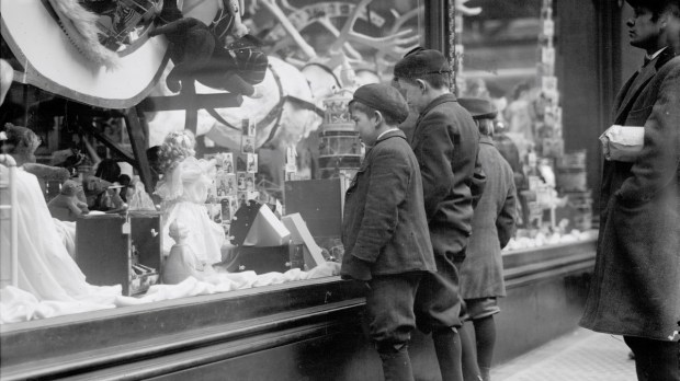 Old photograph of children looking at Christmas toys in shop window