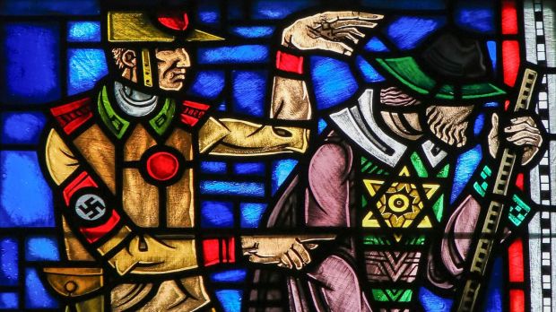 Stained glass window denouncing the Nazis' evil acts