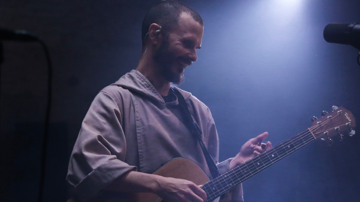 Brother Isaiah smiling with guitar