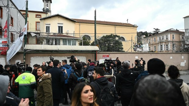 Journalists and bystanders outside Santa Maria Church in Istanbul