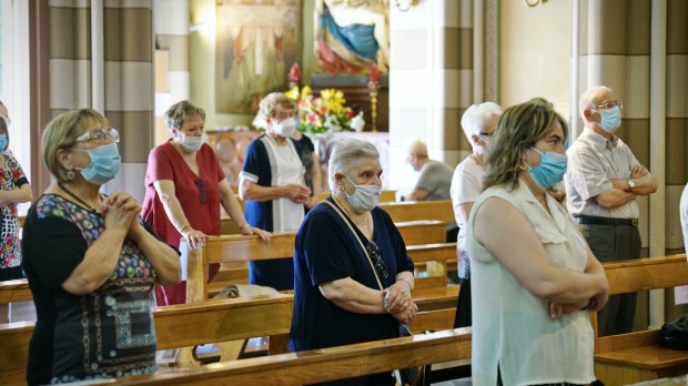 Parishioners in church wear masks during pandemic