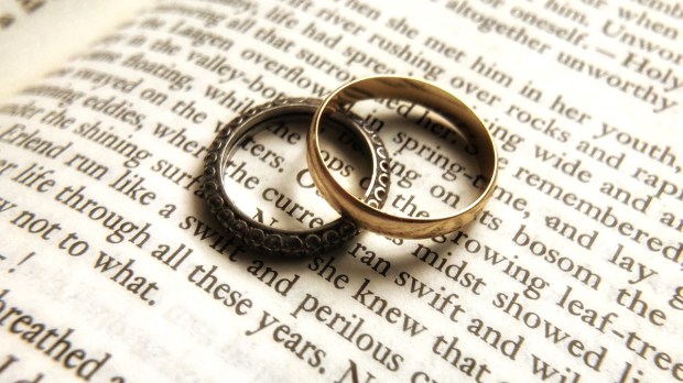 Two wedding rings on book page close up