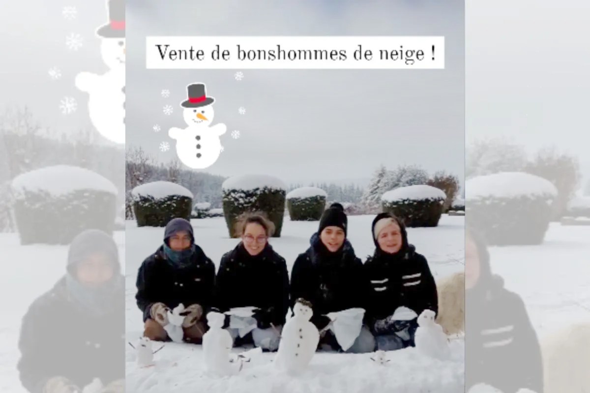 Nuns in the snow making snowmen