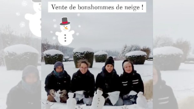 Nuns in the snow making snowmen