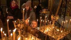 Lighting candles in Ukrainian church